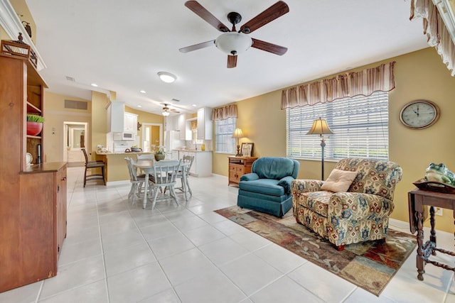 living area featuring a ceiling fan, light tile patterned floors, baseboards, visible vents, and recessed lighting