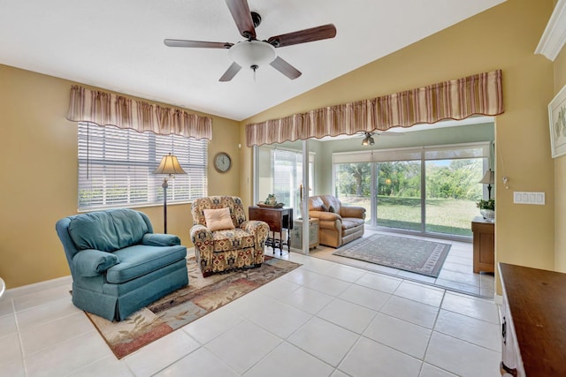 living room with lofted ceiling, ceiling fan, and light tile patterned floors