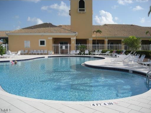 pool with fence and a patio