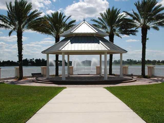 surrounding community with a water view, a gazebo, and a yard