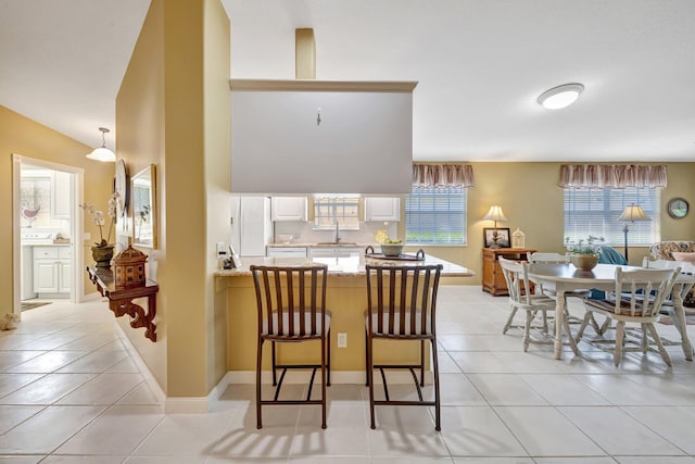 dining area featuring light tile patterned floors