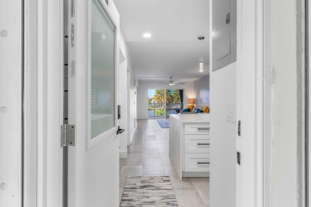 hallway with electric panel and light tile patterned flooring