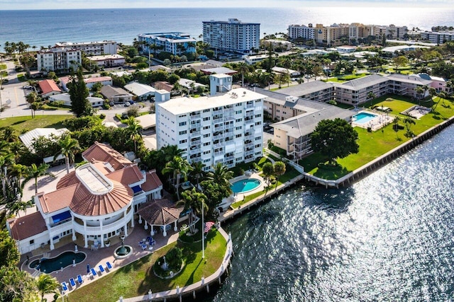 birds eye view of property with a city view and a water view