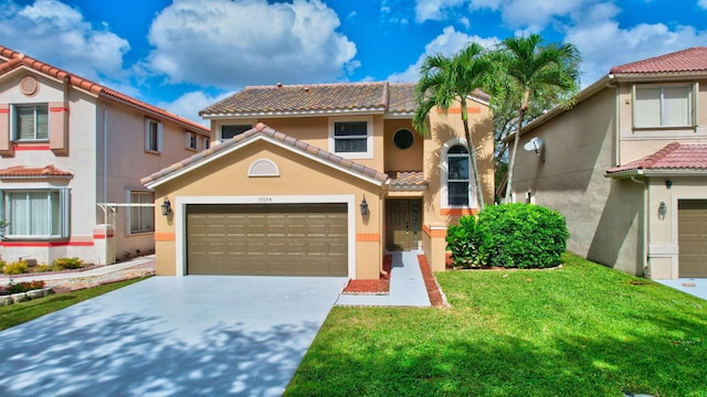 mediterranean / spanish home featuring a front yard, an attached garage, stucco siding, concrete driveway, and a tiled roof