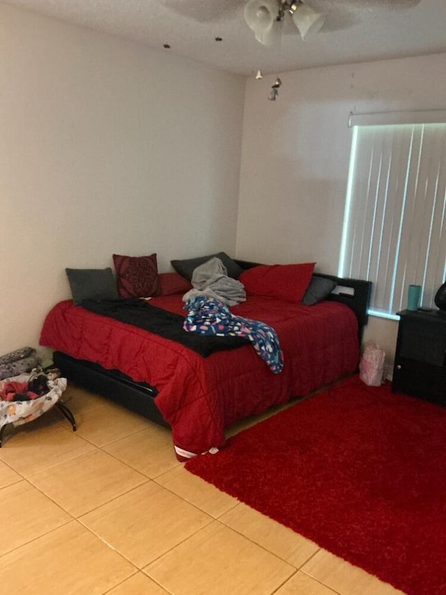 bedroom featuring ceiling fan and tile patterned flooring