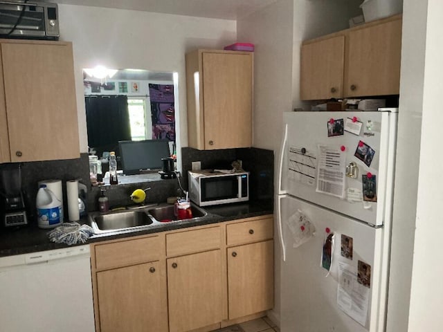 kitchen with white appliances, light brown cabinets, a wall mounted AC, a sink, and dark countertops