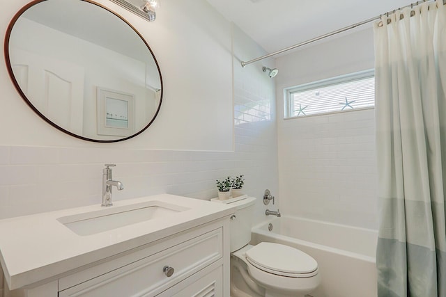 full bath with shower / bath combo with shower curtain, toilet, tile walls, and vanity