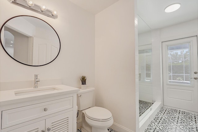 full bath with vanity, baseboards, a tile shower, tile patterned floors, and toilet