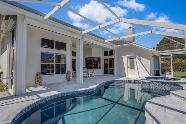 view of pool featuring a lanai, ceiling fan, a pool with connected hot tub, and a patio