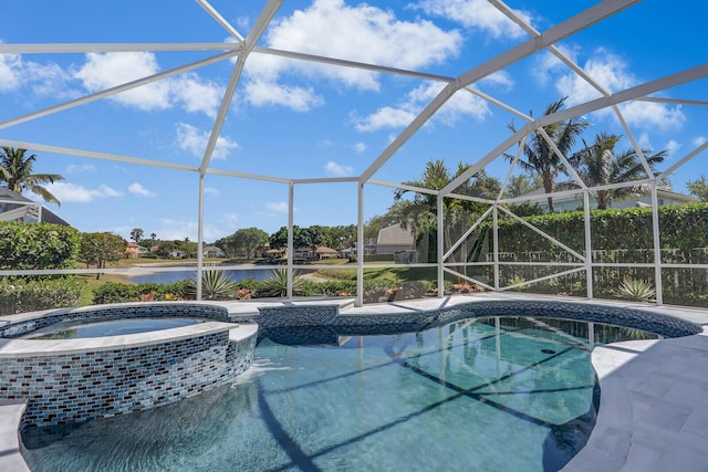 view of pool featuring glass enclosure, a patio area, a water view, and a pool with connected hot tub