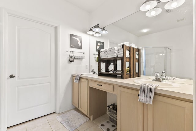 full bath featuring tile patterned floors, double vanity, a stall shower, and a sink