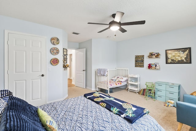 bedroom featuring a ceiling fan, baseboards, visible vents, and carpet floors