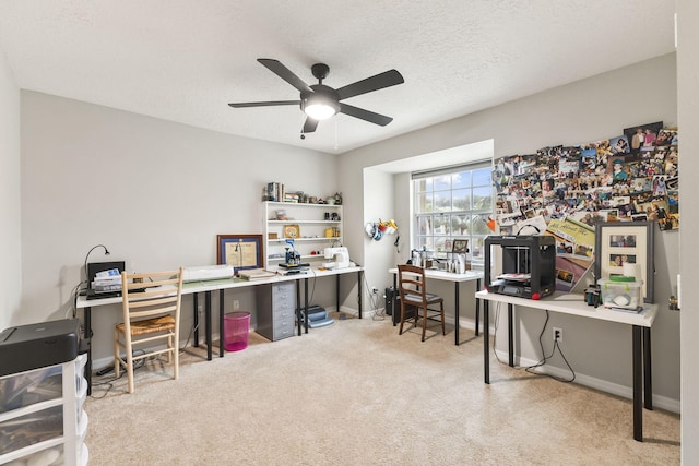 office space with baseboards, carpet floors, a textured ceiling, and ceiling fan