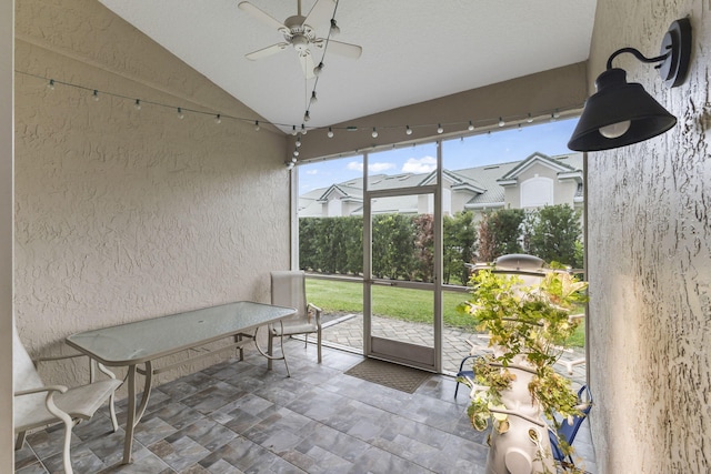 sunroom featuring vaulted ceiling and ceiling fan