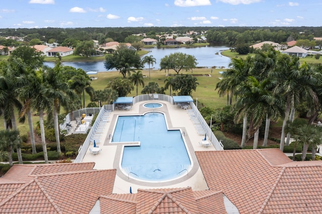 community pool featuring a community hot tub, a patio area, and a water view