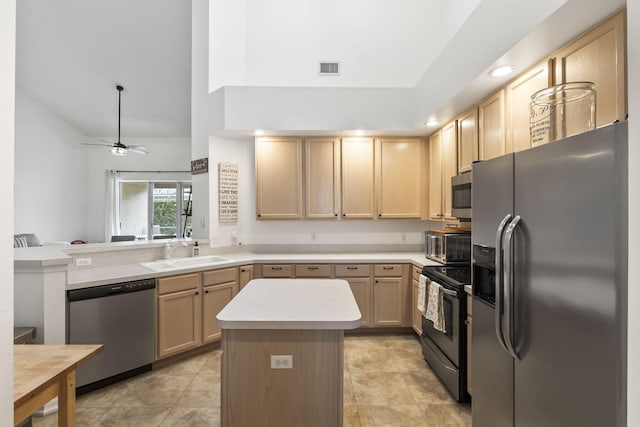 kitchen featuring a sink, stainless steel appliances, light brown cabinets, and light countertops