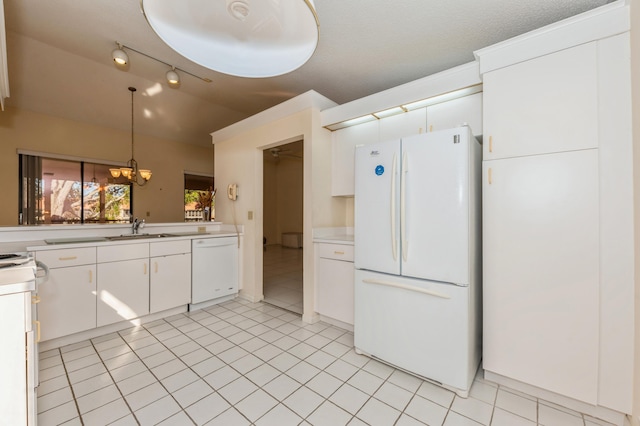 kitchen with white cabinets, white appliances, light countertops, and a sink