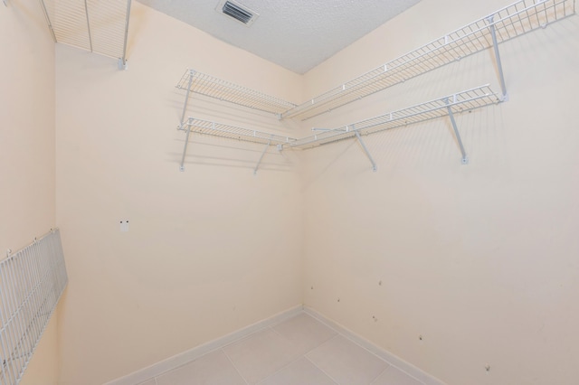 spacious closet with light tile patterned flooring and visible vents