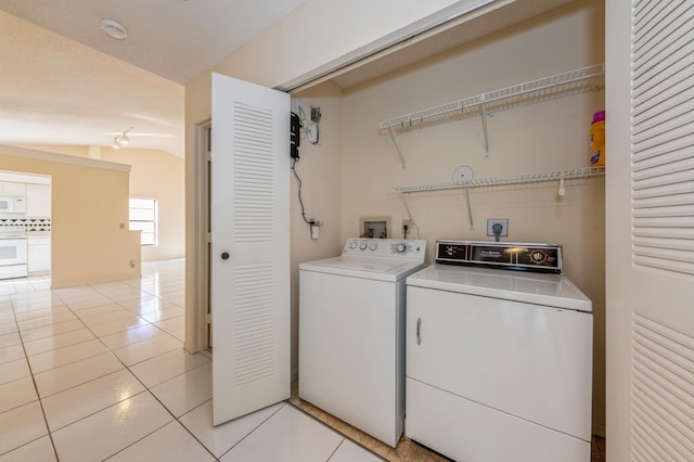 laundry area featuring light tile patterned floors, laundry area, and washing machine and dryer