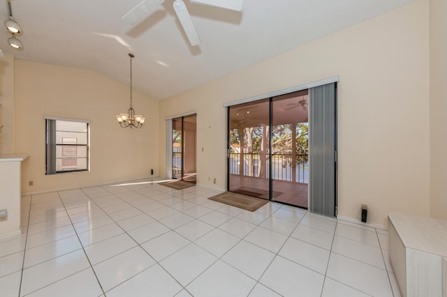 spare room featuring light tile patterned floors, ceiling fan with notable chandelier, and vaulted ceiling