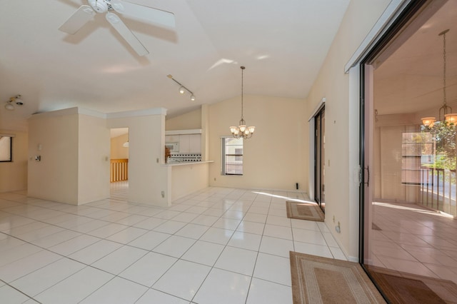 unfurnished room with lofted ceiling, light tile patterned floors, and ceiling fan with notable chandelier