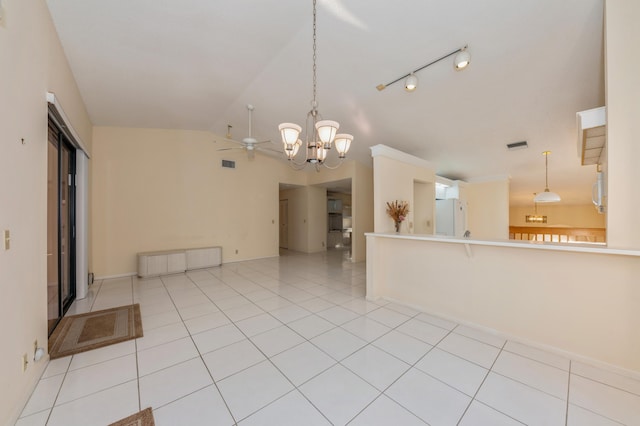 interior space featuring visible vents, ceiling fan with notable chandelier, light tile patterned flooring, baseboards, and vaulted ceiling