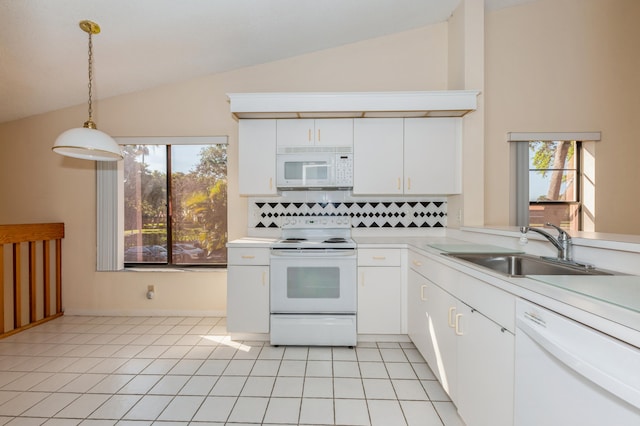 kitchen with white appliances, light tile patterned floors, light countertops, and a sink