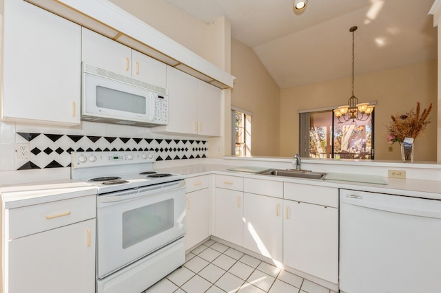 kitchen featuring a sink, white appliances, light tile patterned floors, and light countertops