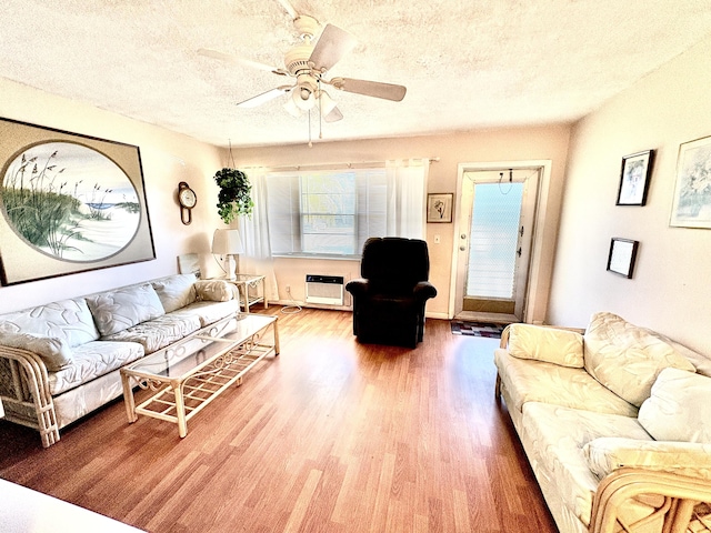 146 Sussex H, West Palm Beach, FL 33417 - living room featuring wood finished floors, a textured ceiling, a ceiling fan, and a healthy amount of sunlight
