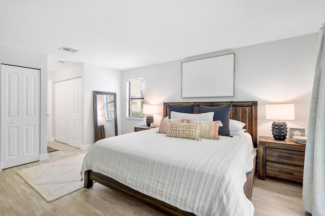 bedroom with visible vents and light wood finished floors