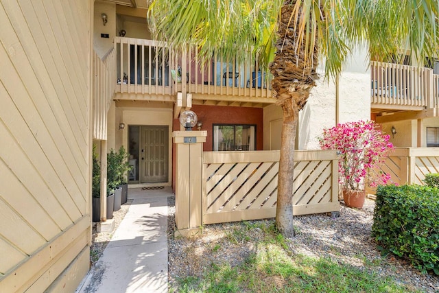 doorway to property with stucco siding and a balcony