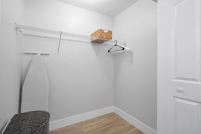 walk in closet featuring light wood finished floors