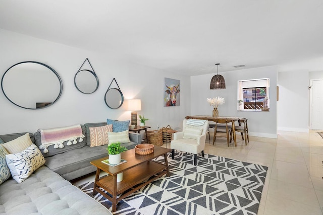 living area with light tile patterned flooring, baseboards, and visible vents