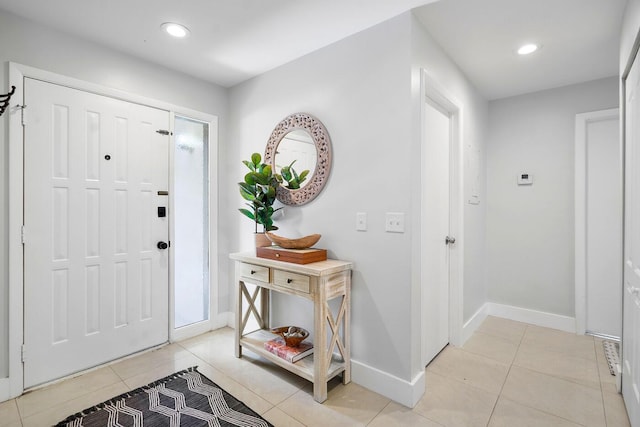 entryway with light tile patterned floors, recessed lighting, and baseboards