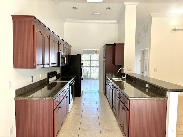 kitchen featuring dark stone countertops, light tile patterned flooring, a sink, stainless steel appliances, and crown molding