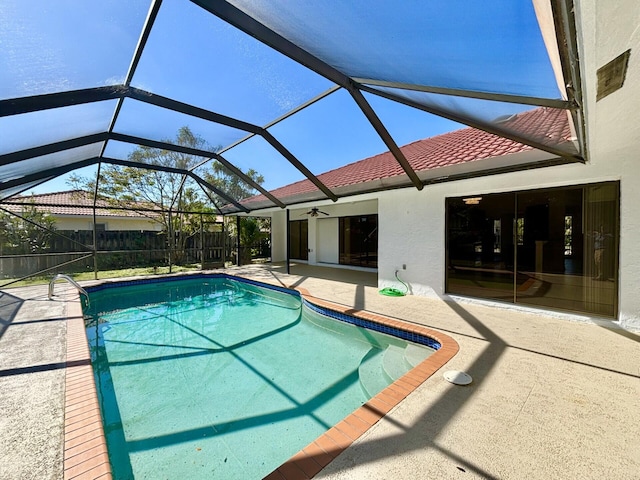 outdoor pool featuring fence, a lanai, and a patio area