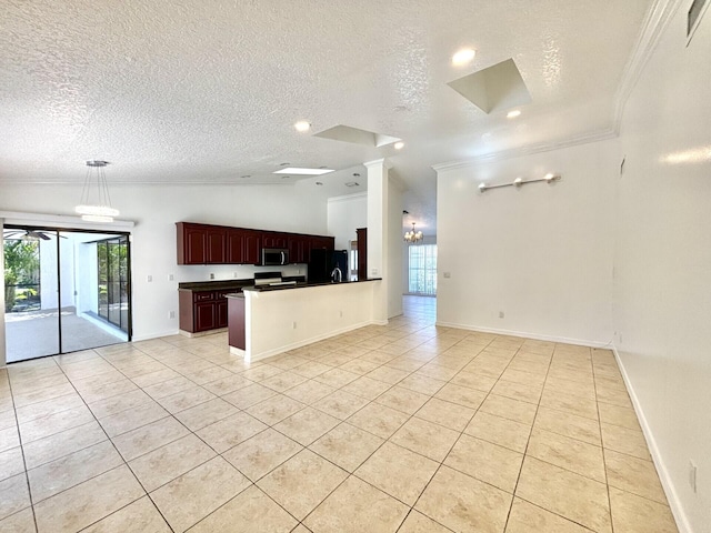 kitchen with dark countertops, stainless steel microwave, open floor plan, and ornamental molding