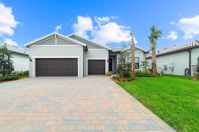 view of front of house with stucco siding, decorative driveway, a front yard, and an attached garage