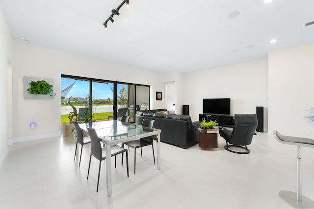 dining room with recessed lighting, baseboards, and rail lighting