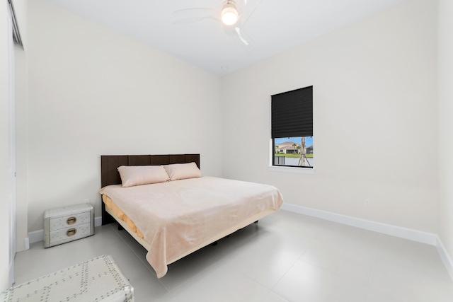 bedroom featuring baseboards and ceiling fan