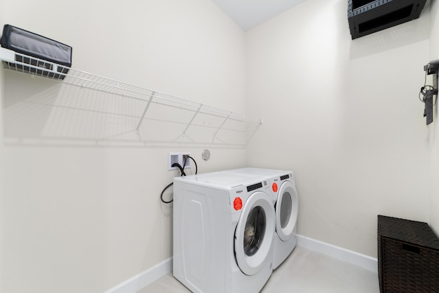 laundry room featuring washer and dryer, baseboards, and laundry area