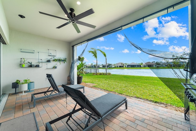 view of patio / terrace featuring a ceiling fan and a water view