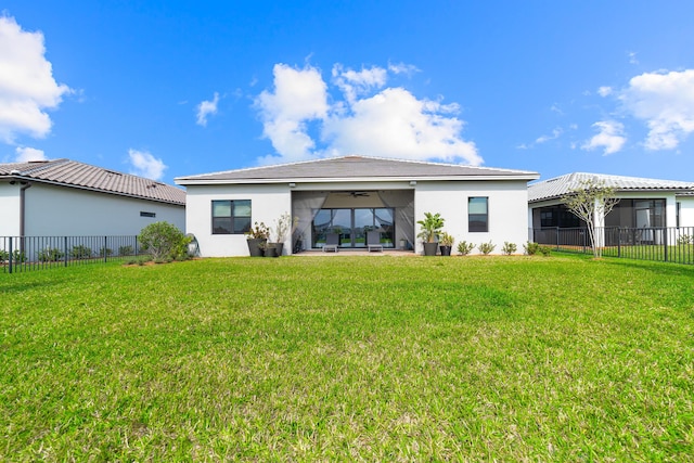 rear view of property with stucco siding, a yard, a fenced backyard, and a ceiling fan