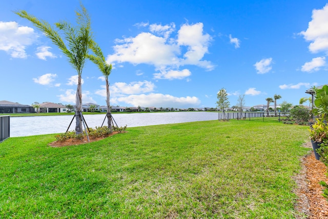 view of yard with fence and a water view