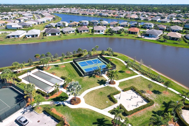 drone / aerial view with a residential view and a water view