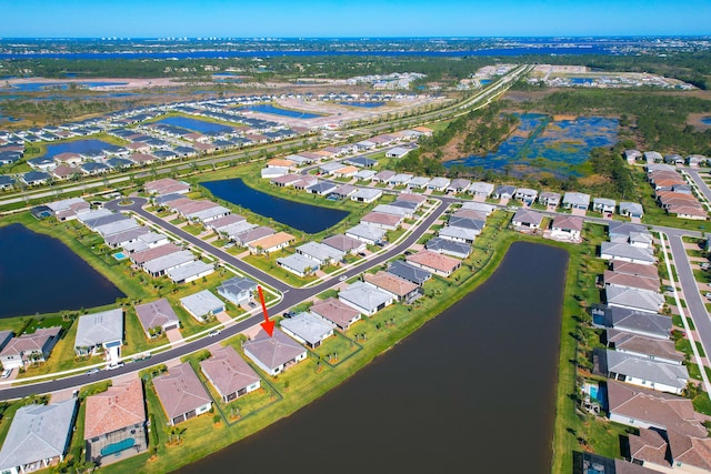 drone / aerial view with a residential view and a water view