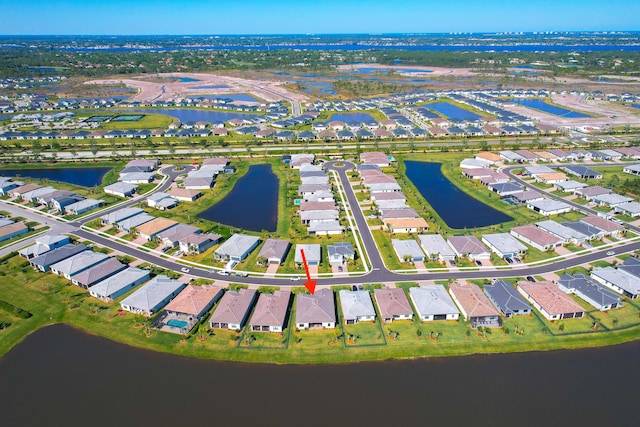 drone / aerial view with a residential view and a water view