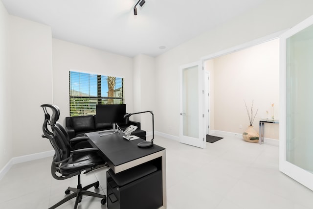 office area featuring rail lighting, french doors, and baseboards