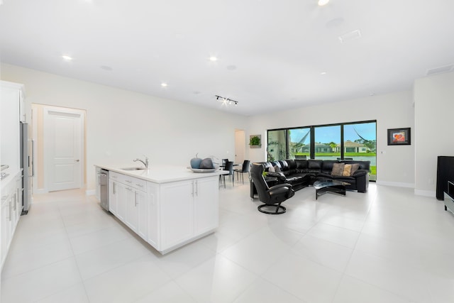 kitchen with visible vents, a sink, white cabinets, appliances with stainless steel finishes, and open floor plan