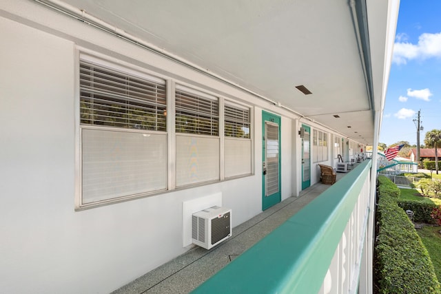 view of patio / terrace featuring a balcony and a wall unit AC